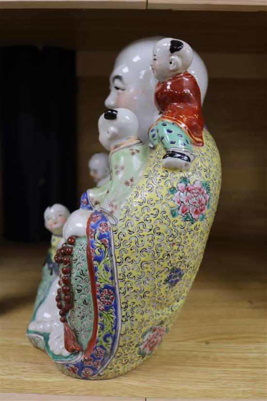 A Chinese enamelled porcelain figure of Budai with attendants height 30cm